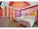 Charming bedroom with princess theme, two beds, and floral ceiling at 4575 Narrative Ln, Kissimmee, FL 34746