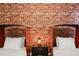 Two twin beds in a ' bedroom with a brick feature wall at 4575 Narrative Ln, Kissimmee, FL 34746