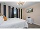 King-size bed in a bedroom with black and white striped walls, and a modern chandelier at 4575 Narrative Ln, Kissimmee, FL 34746