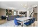 Open concept dining area with white table and blue velvet chairs at 4575 Narrative Ln, Kissimmee, FL 34746