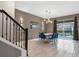 Modern dining room with a white table, blue chairs, and pool view at 4575 Narrative Ln, Kissimmee, FL 34746