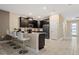 Modern kitchen with dark cabinetry and a breakfast bar at 4575 Narrative Ln, Kissimmee, FL 34746