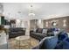 Open living room with comfortable seating and a large TV at 4575 Narrative Ln, Kissimmee, FL 34746