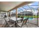 Covered patio with seating area and view of the pool at 4575 Narrative Ln, Kissimmee, FL 34746