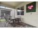 Covered patio with table and chairs, perfect for outdoor dining at 4575 Narrative Ln, Kissimmee, FL 34746