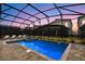 Inviting screened pool and spa area with lounge chairs at 4575 Narrative Ln, Kissimmee, FL 34746