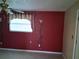Living room features red accent wall and tile flooring at 4824 Shoshone St, Orlando, FL 32819