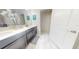 Clean bathroom with dual sinks and a separate toilet area at 4902 Windermere Ave, Kissimmee, FL 34746
