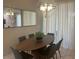 Bright dining room with oval wood table and six gray chairs at 4902 Windermere Ave, Kissimmee, FL 34746