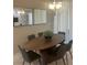 Bright dining room with oval wood table and six gray chairs at 4902 Windermere Ave, Kissimmee, FL 34746