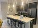 Modern kitchen featuring dark cabinetry and a breakfast bar at 4902 Windermere Ave, Kissimmee, FL 34746