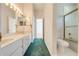 Bathroom boasts double vanity, shower, and gold accents at 5666 Merlin Way, St Cloud, FL 34772