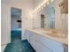 Double vanity bathroom with view into bedroom at 5666 Merlin Way, St Cloud, FL 34772
