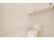Small bathroom with toilet and overhead cabinet at 5666 Merlin Way, St Cloud, FL 34772