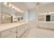Large bathroom with double vanity and walk-in shower at 5666 Merlin Way, St Cloud, FL 34772