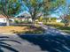 House with a circular driveway and lush green lawn at 5666 Merlin Way, St Cloud, FL 34772