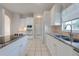 Bright kitchen features granite countertops, white cabinets, and modern appliances at 5666 Merlin Way, St Cloud, FL 34772