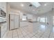 Bright kitchen with white cabinets, granite counters, and island at 5666 Merlin Way, St Cloud, FL 34772