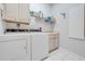 Laundry room with washer, dryer, cabinets, and sink at 5666 Merlin Way, St Cloud, FL 34772