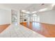 Spacious living room with hardwood and tile floors, and fireplace at 5666 Merlin Way, St Cloud, FL 34772
