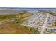 Aerial perspective showcasing a waterfront community with numerous houses and lush natural surroundings at 1067 Haines Dr, Winter Haven, FL 33881