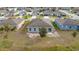 Backyard view of a house with a small patio, featuring a simple landscape at 1067 Haines Dr, Winter Haven, FL 33881