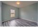 Light and airy bedroom with grey wood flooring at 1067 Haines Dr, Winter Haven, FL 33881