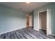 Bedroom with grey wood flooring and access to a bathroom at 1067 Haines Dr, Winter Haven, FL 33881