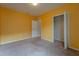 Bedroom with yellow walls, carpet flooring, and a walk-in closet at 1067 Haines Dr, Winter Haven, FL 33881