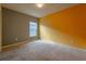 Bright bedroom with gray and orange walls, carpet flooring, and a window at 1067 Haines Dr, Winter Haven, FL 33881