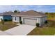 Newly constructed one-story home with attached garage and landscaped yard at 1067 Haines Dr, Winter Haven, FL 33881