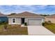 One-story house with a gray exterior, attached garage, and a neatly kept yard at 1067 Haines Dr, Winter Haven, FL 33881