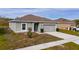 Newly built one-story house featuring a two-car garage and well-maintained lawn at 1067 Haines Dr, Winter Haven, FL 33881