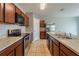 Modern kitchen with stainless steel appliances and dark brown cabinets at 1067 Haines Dr, Winter Haven, FL 33881