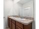 Double vanity with granite countertop in a bright bathroom at 113 Eagleview Loop, Davenport, FL 33837