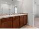 Double vanity bathroom with a large mirror at 113 Eagleview Loop, Davenport, FL 33837