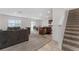 Spacious living room with grey sofas and view of kitchen at 113 Eagleview Loop, Davenport, FL 33837