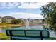 Green bench overlooks a pond with fountain at 113 Eagleview Loop, Davenport, FL 33837