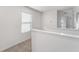 Upstairs hallway with neutral carpeting and a window at 113 Eagleview Loop, Davenport, FL 33837
