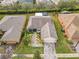 Aerial view of single-story house with landscaped yard and paver driveway at 119 Verona Dr, Kissimmee, FL 34759