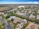 Aerial view of residential neighborhood with houses and distant lake at 119 Verona Dr, Kissimmee, FL 34759