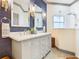 Updated bathroom featuring a double vanity, elegant wall decor and a shower at 119 Verona Dr, Kissimmee, FL 34759