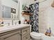 Clean bathroom with a shower/tub combo, vanity with quartz countertop and decorative accents at 119 Verona Dr, Kissimmee, FL 34759