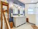 Modern bathroom with double vanity, stylish mirrors, and a walk-in shower at 119 Verona Dr, Kissimmee, FL 34759