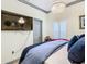 Bedroom with large TV, queen bed, and window shutters at 119 Verona Dr, Kissimmee, FL 34759