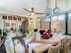 Sunroom dining area, featuring a light wood table and playful accents at 119 Verona Dr, Kissimmee, FL 34759