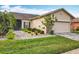 Single-story home with landscaped yard and attached garage at 119 Verona Dr, Kissimmee, FL 34759