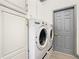 Convenient laundry room with washer, dryer, and extra storage cabinets at 119 Verona Dr, Kissimmee, FL 34759