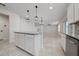 Kitchen island with white cabinets and granite countertop at 1210 Michelangelo Ln, Winter Haven, FL 33884