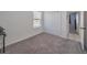 Spacious bedroom with carpet, large closet and access to a hallway at 123 Zinnia W Ln, Poinciana, FL 34759